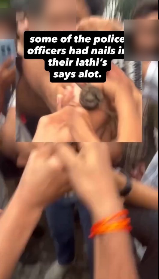 Close-up of hands holding a lathi tip with a nail through it